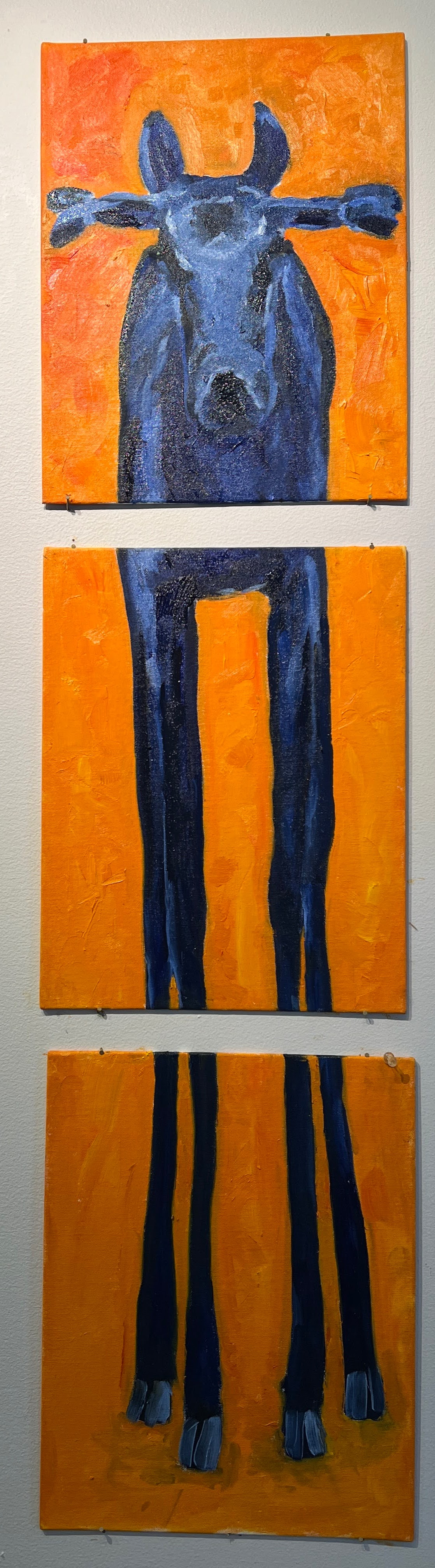 blue moose in three parts patinted on an orange background