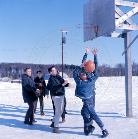 Children playing basketball at the Soldotna Elementary playground, Soldotna 1967