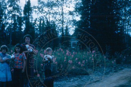 Carol Dubendorf, Maude Dubendorf, and Billy Stock holding bunnies, Soldotna 1953