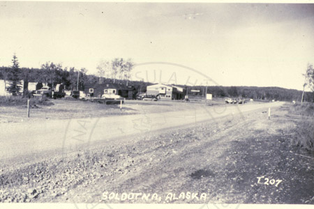 Sterling Highway near Kenai River Bridge with a view of Davenports bar and café, Soldotna 1955