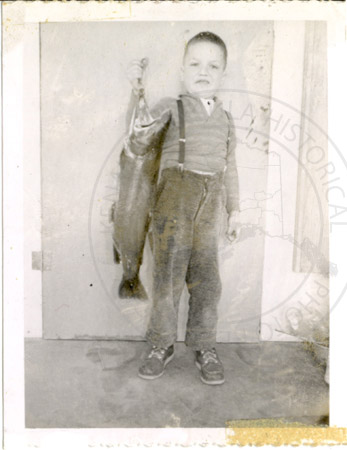 Young Joe Byrd holding a salmon, Soldotna 1961