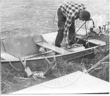 Moose hunter in boat, Kenai River 1960