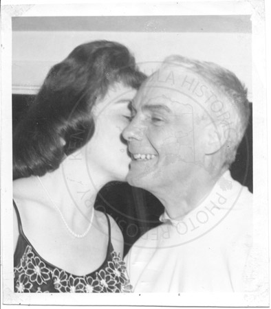 Alaska State Champion sled dog races, Dr. Roland Lombard receiving kiss on the cheek from Barbara O'Rourke, Soldotna 1962