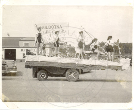 Amber Burton and Velma McFarland on the Nestor Concrete Products float at Soldotna Progress Days parade, Soldotna 1961