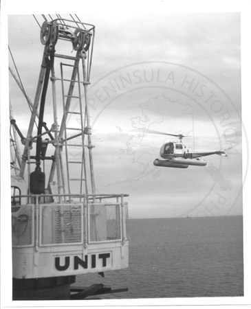 Approaching helicopter at oil platform, upper Cook Inlet mid 1960's