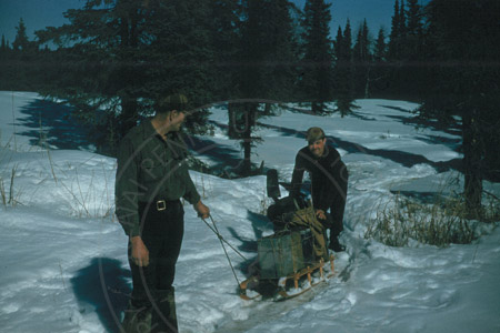 Jim Bergsrud and Virgil Dahler hauling clams, Clam Gulch early 1950's