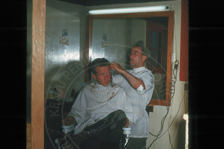 Frenchy the barber and Don Smith at Frenchy's barber shop, Kenai mid 1950's