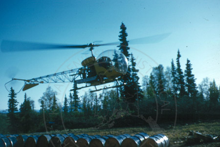 Helicopter and empty fuel barrels, west Cook Inlet early 1960's