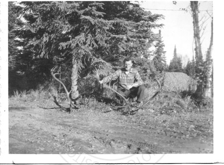 Man posed with two caribou racks, Kenai Peninsula mid 1960's