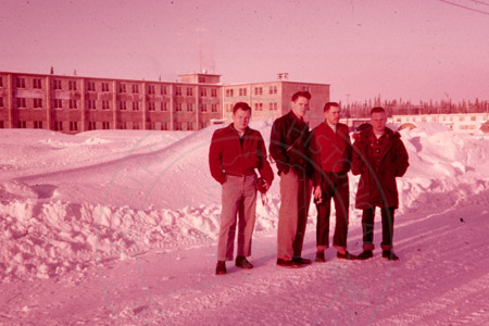 Four G.I servicemen posing in front of Wildwood Air Force Station, Kenai 1956
