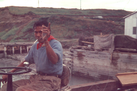 Frank the cannery worker guiding an operation at a dock, Kenai 1956