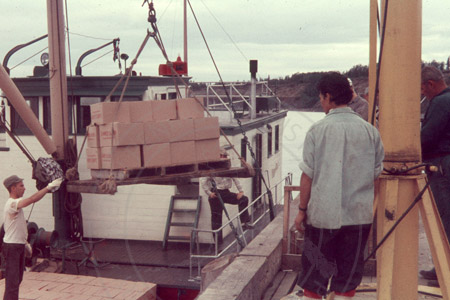 Loading a boat with canned salmon, Kenai 1956