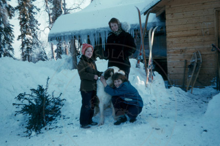Abby, Martha and Laurie Lancashire with Mable the dog at the Lancashire homestead, Soldotna 1956