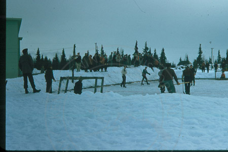 People playing hockey at the Kenai Territorial school ice rink, Kenai 1956