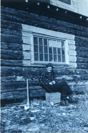 Ed Ciechanski resting after setting a window at his homestead, Soldotna 1960's