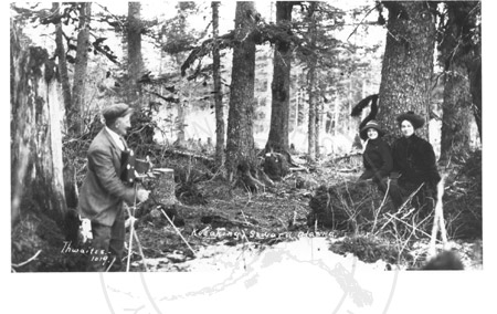 Photographer and subjects among the Sitka spruce, Seward early 1900's