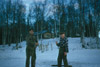 Robert J. Mackey and Chell Bear ice fishing at the Mackey cabin, Soldotna 1955