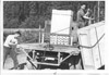 Tachick Freight business partners Roger and Wayne Tachick loading crates, Soldotna 1960's
