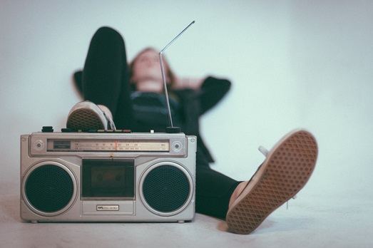 person laying down with foot on radio